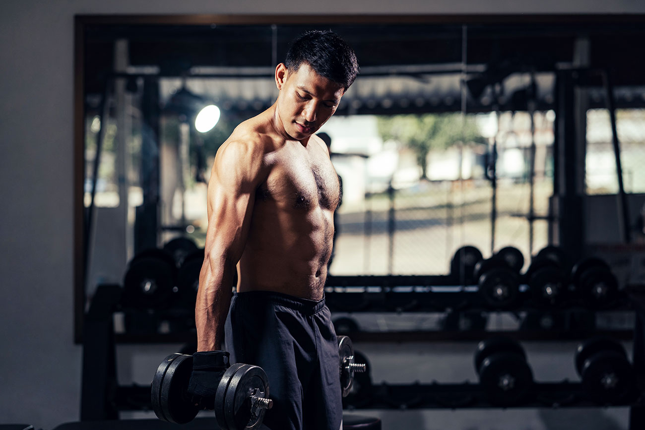 Shirtless Dark Haired Man With Weights