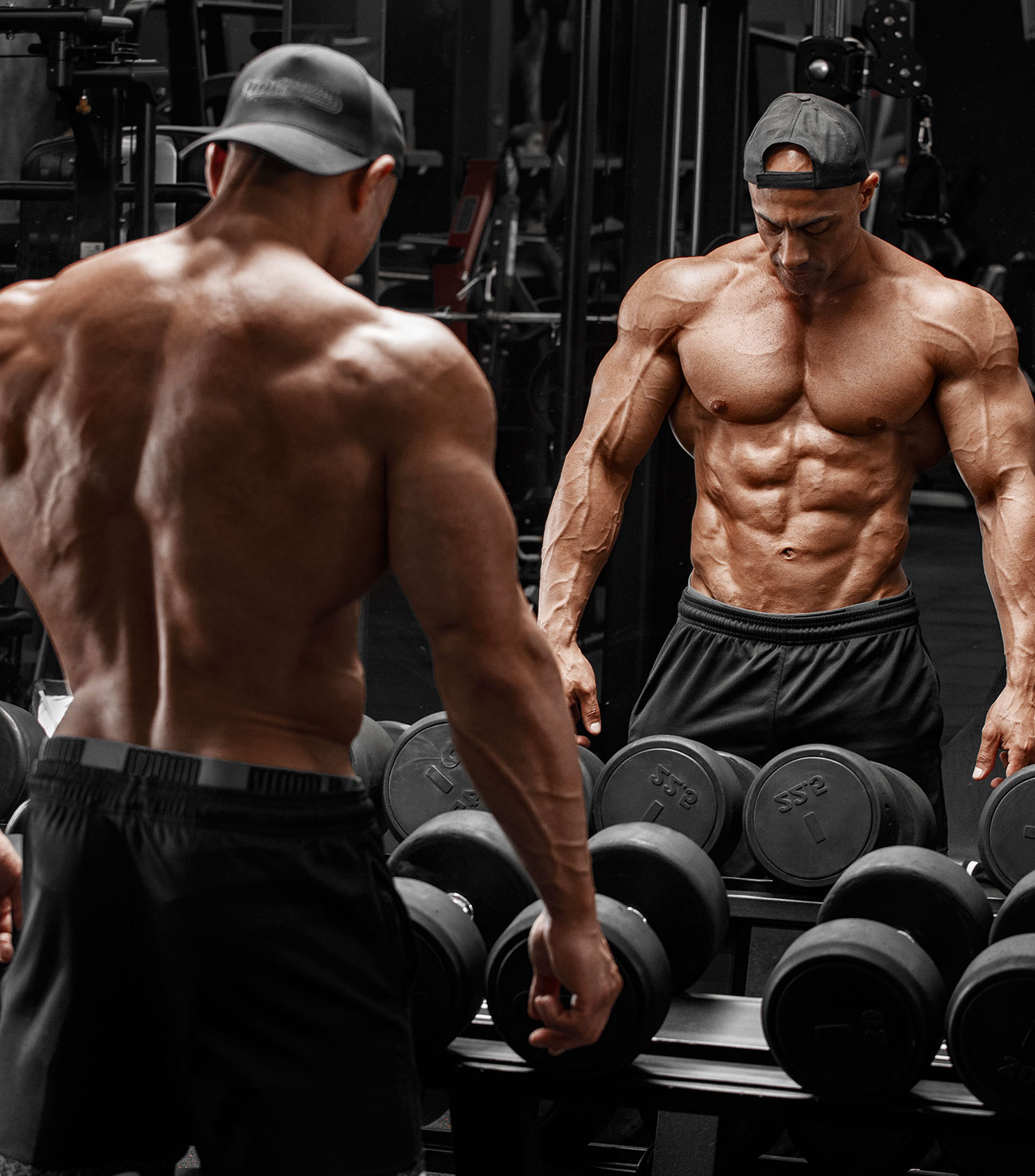 Muscular Guy with a Six Pack Posing In Front of a Mirror