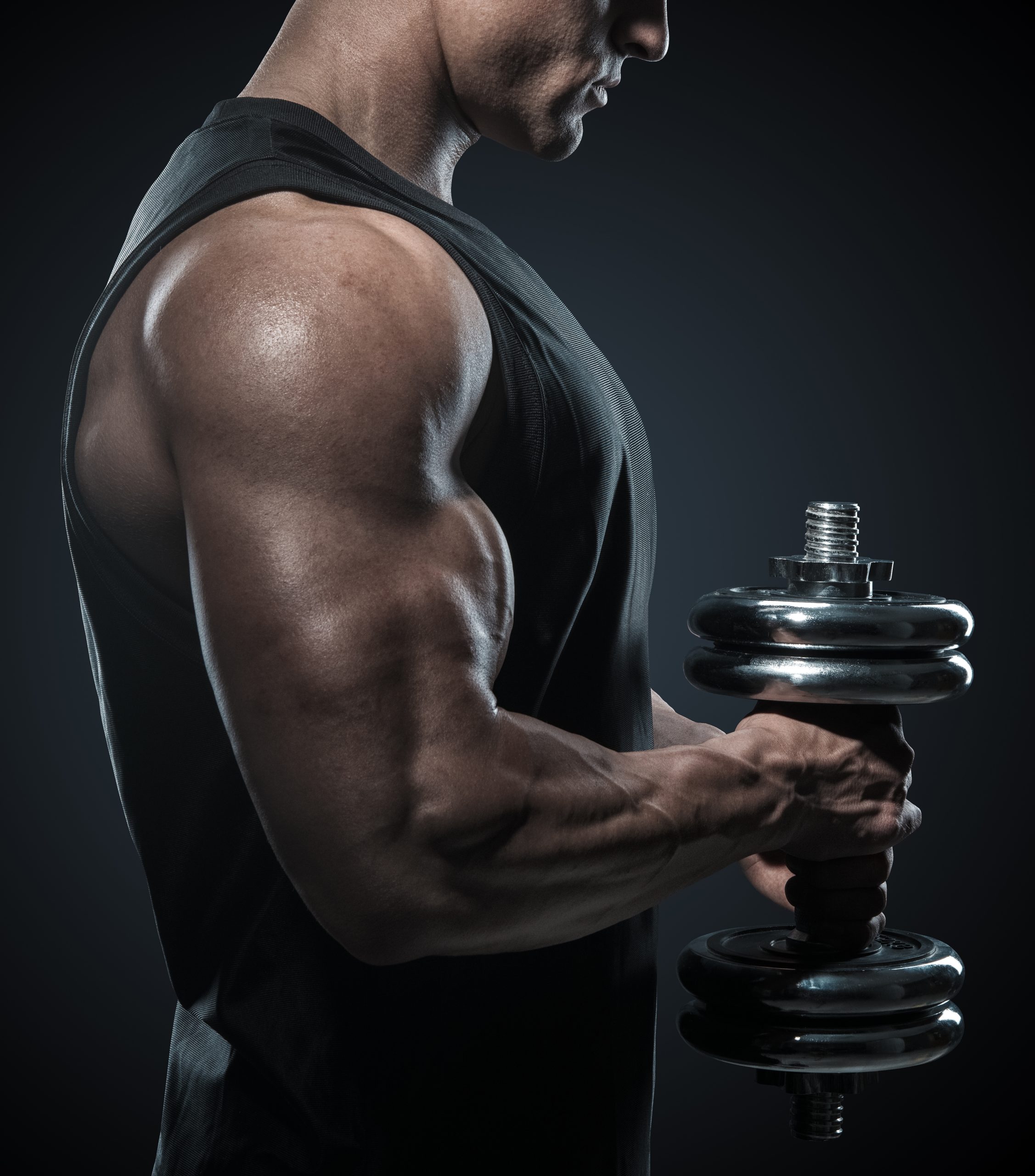 Muscular Guy Doing Dumbell Curls